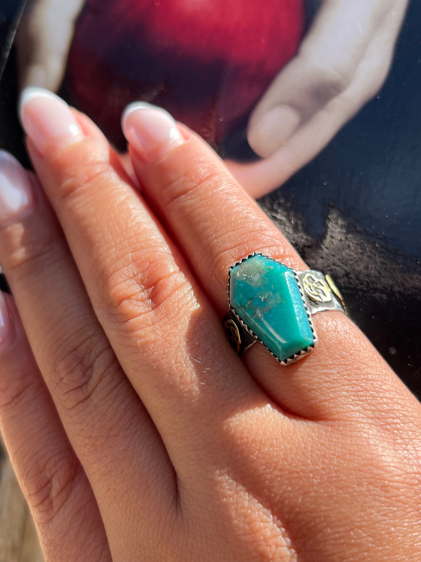 Turquoise ring with brass skulls 9 1/4 in